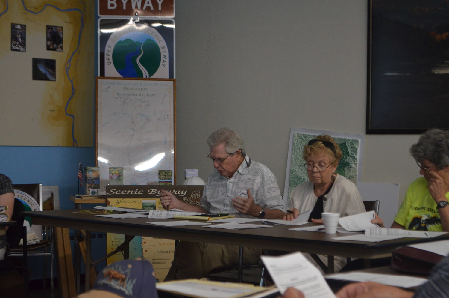 Upper Delaware Council chairperson and Highland representative Andy Boyar, left, discussing the Camp FIMFO project with Tusten representative Susan Sullivan and Deerpark representative Ginny Dudko.